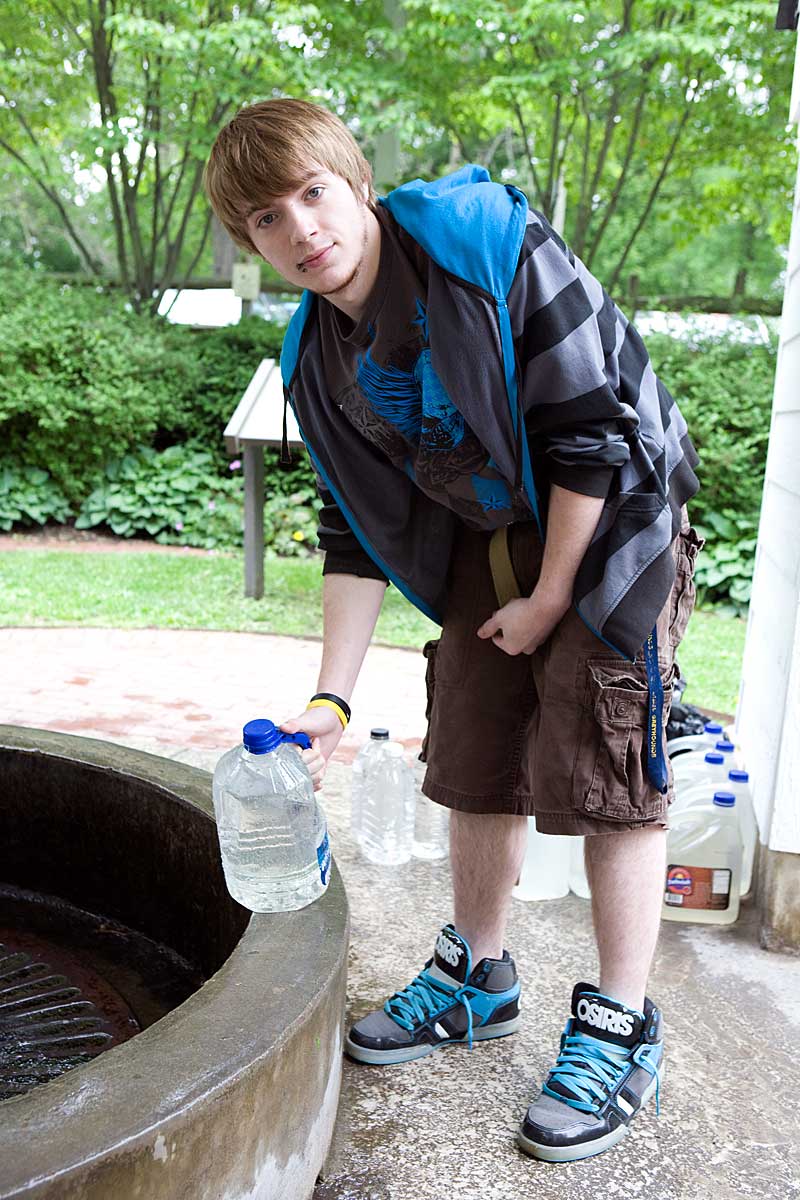 Young man getting water for his family, Flowing Well Park, Carmel IN