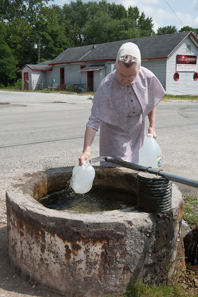 Woman gathering water at the Pittsburg Flowing Well